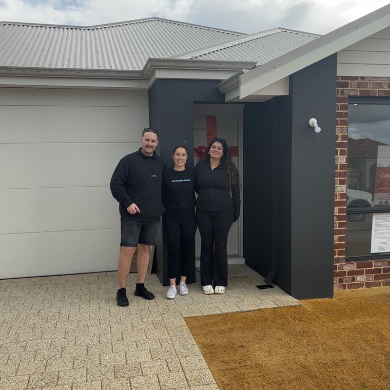 House of Boss clients with their keys outside their new home.