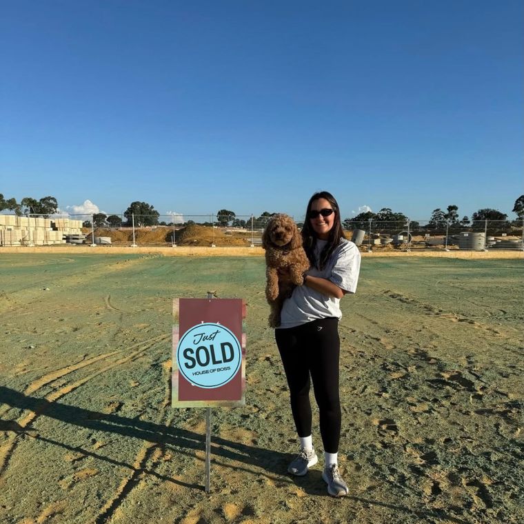 A House of Boss client with the Sold sign on her new block.