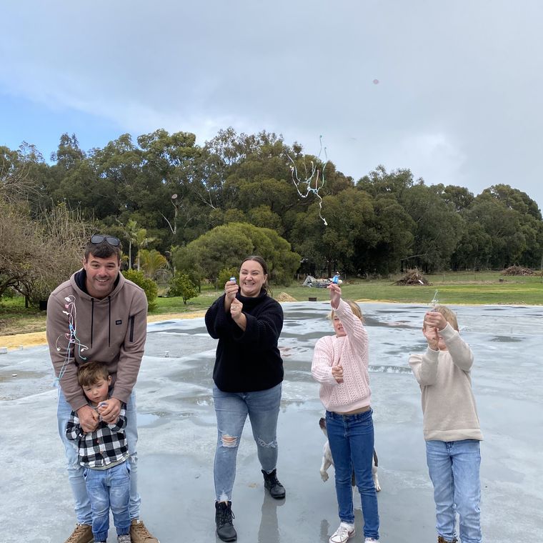 House of Boss clients standing on their new slab.