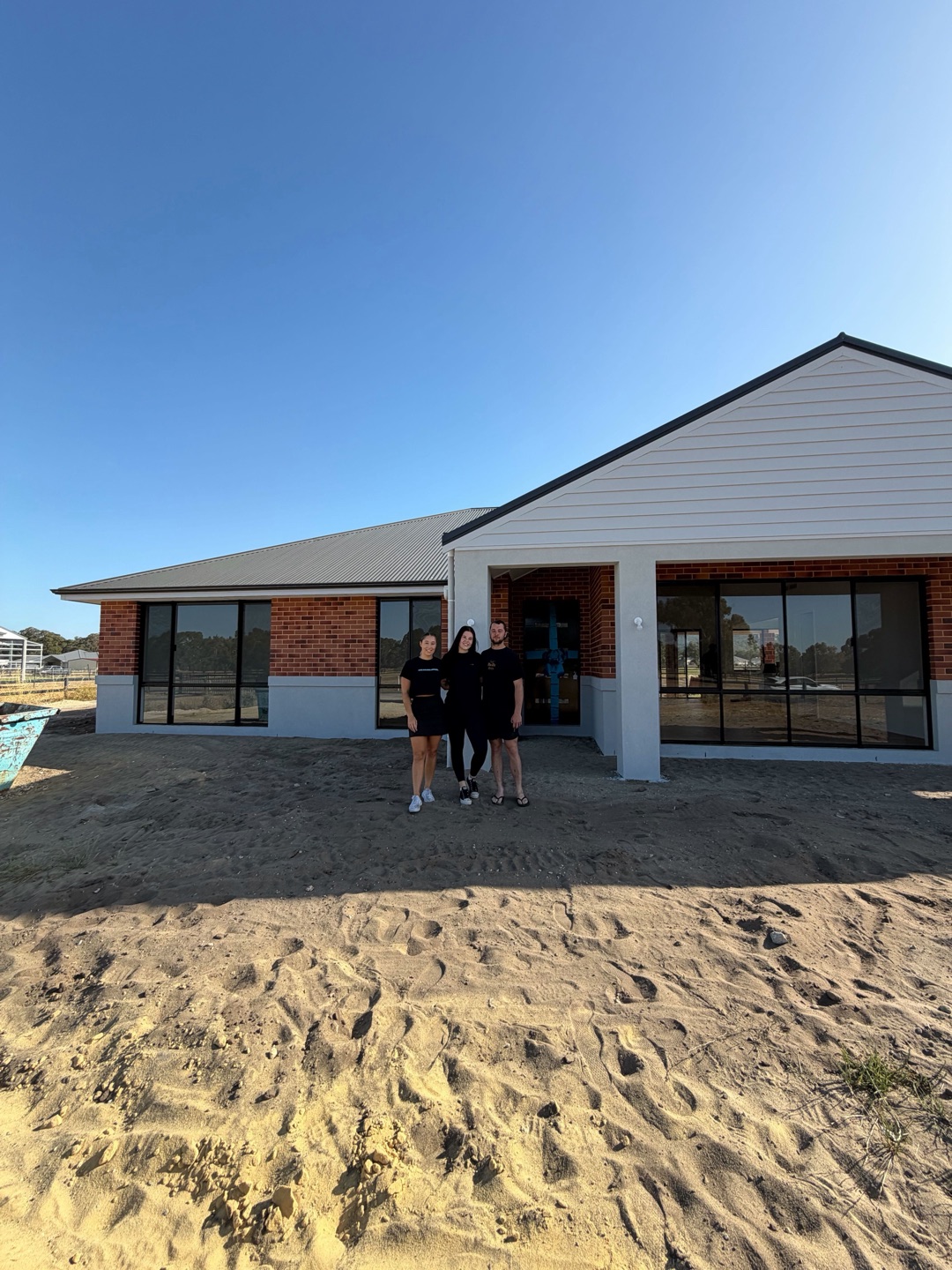 A House of Boss family at handover, in front of their finished new Perth home.